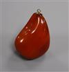 A yellow metal mounted natural amber pebble pendant, with GCS certificate dated 8/5/19.                                                
