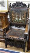 Two carved Spanish elbow chairs                                                                                                        