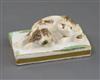 A Rockingham porcelain figure of a recumbent cocker spaniel, c.1830, L. 6.8cm                                                          