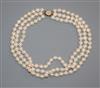 A triple strand cultured pearl choker necklace with yellow metal and cultured pearl set clasp, 36cm.                                   