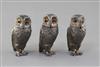 A set of three 1960's novelty silver three piece condiment set, each modelled as a free standing owl, by William Comyns & Sons,        