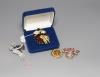 Four items of designer costume jewellery, including a Camrose & Kross 'Jacqueline Kennedy' reproduction flower brooch                                                                                                       