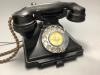 A black bakelite telephone                                                                                                                                                                                                  