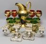 A Venetian green glass lemonade set, 4 red glass wine glasses and a pair of plated candelabra, jug 29 cms high.                                                                                                             