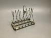 A novelty golfing silver plated toast rack                                                                                                                                                                                  