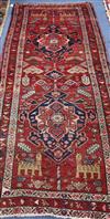 A Caucasian red ground hall carpet 257 x 109cm                                                                                         