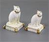 Two Rockingham porcelain figures of a cat seated on a tasselled cushion, c.1830, 5.5cm and 6.4cm, largest restored                     