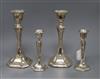 A pair of George V silver pillar waisted candlesticks (Chester 1911) and a smaller pair of candlesticks, tallest 25.3cm.               