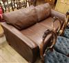 A modern brown leather two seater settee                                                                                               