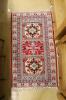 A Kazak style ivory ground rug, 144 x 64cm                                                                                                                                                                                  