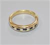 A modern 18ct gold and channel set sapphire and diamond nine stone half hoop ring, size N.                                             