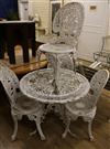 A set of four white painted cast aluminium Coalbrookedale style garden chairs and a matching table                                     