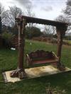 A large Florentine style carved wood garden swing                                                                                      