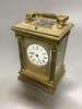 A large French gilt brass repeating carriage clock, signed EM and co.                                                                                                                                                       