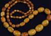 A single strand graduated oval amber bead necklace, 78cm.                                                                              