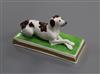 An English porcelain figure of a recumbent brown and white setter, c.1830-50, possibly Davenport, L. 11.4cm                            