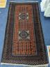 A Belouch red ground rug, 210 x 114cm                                                                                                                                                                                       