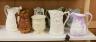 Eight Victorian relief moulded earthenware jugs relating to historic battles and the military                                                                                                                               