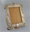 An Edwardian Art Nouveau repousse silver mounted photograph frame by William Neale, Birmingham, 1906, 32cm.                            