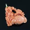 A 20th century 18ct gold mounted coral pendant, carved with flowers, gross weight 20.4 grams.                                          