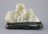 A Chinese pale celadon jade boulder carving, Qing dynasty, 13cm wide, the spinach green jade stand probably later                      