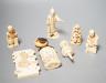 Three Japanese Ivory figures of men, a similar bezique marker, a Japanese staghorn single section inro with ivory manju, a Chinese ivory carving and a bone needlework container                                            