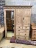 An Edwardian pine compactum wardrobe retailed by Maple & Co., length 113cm, depth 60cm, height 196cm                                                                                                                        