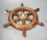 A teak and brass mounted Ship's wheel signed Lawrence Simpson 47cm                                                                                                                                                          