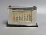 A modern silver mounted ebonised wood desk calendar, Birmingham, 1953, base 21.2cm.                                                                                                                                         
