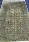 A Bokhara green ground carpet 255cm x 158cm                                                                                            