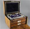 A Victorian burr walnut two drawer travelling toilet box containing ten silver mounted jars or bottles, by William Neal,               