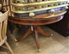 A modern yew breakfast table, with substantial circular plate glass top                                                                