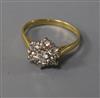 A modern 18ct gold and seven stone diamond cluster ring, size M.                                                                       