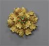 A continental 18k yellow metal and emerald set flower head brooch, 35mm.                                                               