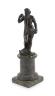 A small Roman bronze figure of Neptune standing with his foot upon a dolphin, overall height 21cm                                                                                                                           