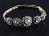 An antique gold and graduated quintuple diamond cluster set bracelet (a.f.),                                                           