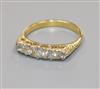 A yellow metal and graduated five stone diamond half hoop ring, size N.                                                                