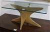 A modern teak glass topped coffee table W.61cm.                                                                                        