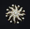 An Edwardian gold and graduated split pearl swirl sunburst pendant brooch, 31mm.                                                       