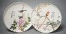A pair of Chinese famille rose dishes, Qianlong marks possibly Republic period, each painted with a bird perched amid prunus and bamboo or red blossom and peonies, inscribed, D. 22cm                                      