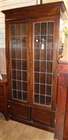 A 1920's oak leaded light bookcase W.96cm                                                                                              