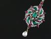 A 19th century gold and silver, emerald, ruby, diamond, two colour enamel and baroque pearl drop oval pendant, overall 6cm.            