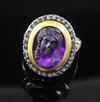 A 19th century amethyst glass? oval cameo ring, with rose cut diamond set border, (adapted?), size M.                                  