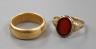 A George V 18ct gold wedding band, size Q, 14 grams and a 333 standard yellow metal and carnelian set signet ring, size R, gross weight 2.8 grams.                                                                          