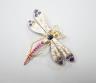 A Victorian style 14k, ruby, sapphire and diamond set dragonfly brooch, 47mm, gross weight 18.5 grams.                                                                                                                      