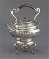 An Edwardian demi-fluted silver tea kettle on stand, with burner, by Edward Barnard & Sons Ltd, gross 58 oz.                           