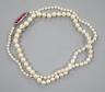 An early 20th century single strand graduated pearl necklace(pearls have not been tested as to whether or not they are natural), five stone ruby set yellow metal clasp, 44cm, gross weight 8.7 grams                       