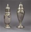 Two early 20th century silver sugar casters (loaded), tallest 18.5cm.                                                                  