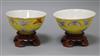 A pair of Chinese Tongzhi yellow ground butterfly bowls, wood stands diameter 11cm                                                     