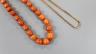 A group of graduated Egyptian coral beads, now strung on a later yellow metal necklace, 62cm                                                                                                                                